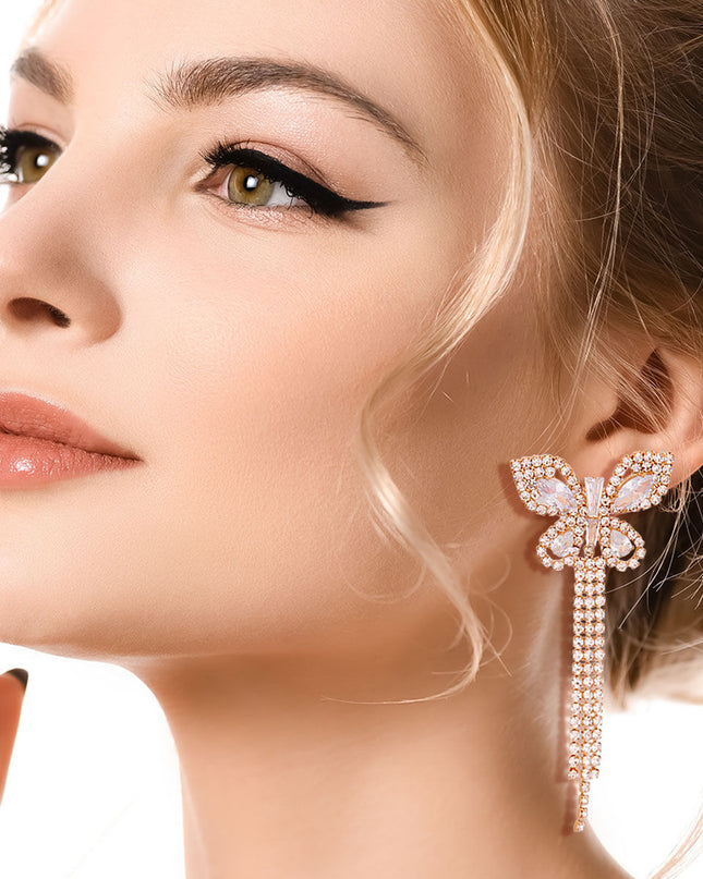 Gold Metal Butterfly Stud Earrings Featuring Rhinestone and Drop Fringe Detailing. Earrings measure 1.25 inches wide