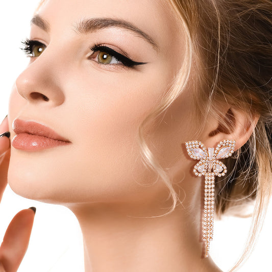 Gold Metal Butterfly Stud Earrings Featuring Rhinestone and Drop Fringe Detailing. Earrings measure 1.25 inches wide
