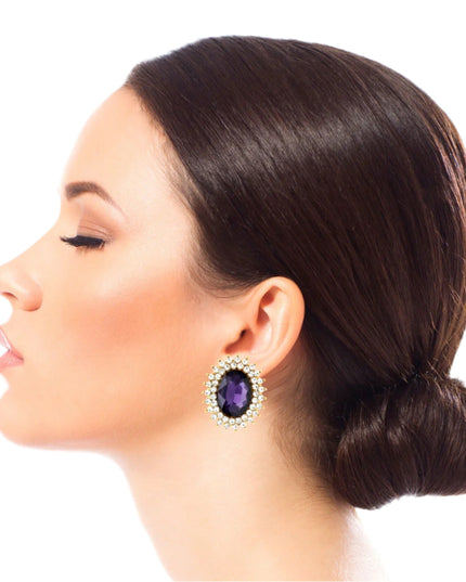 Gold Metal Oval Stud Earrings Featuring Purple Crystal with Rhinestone Trim. Earrings measure .85 inches wide