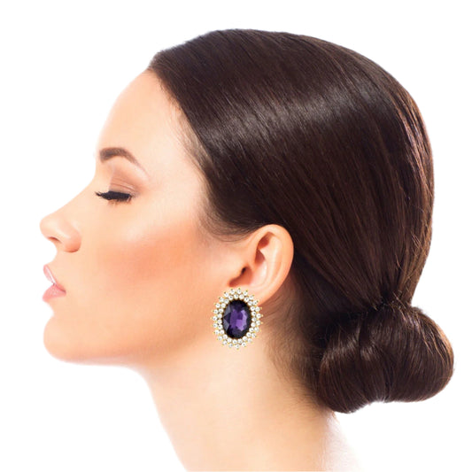Gold Metal Oval Stud Earrings Featuring Purple Crystal with Rhinestone Trim. Earrings measure .85 inches wide