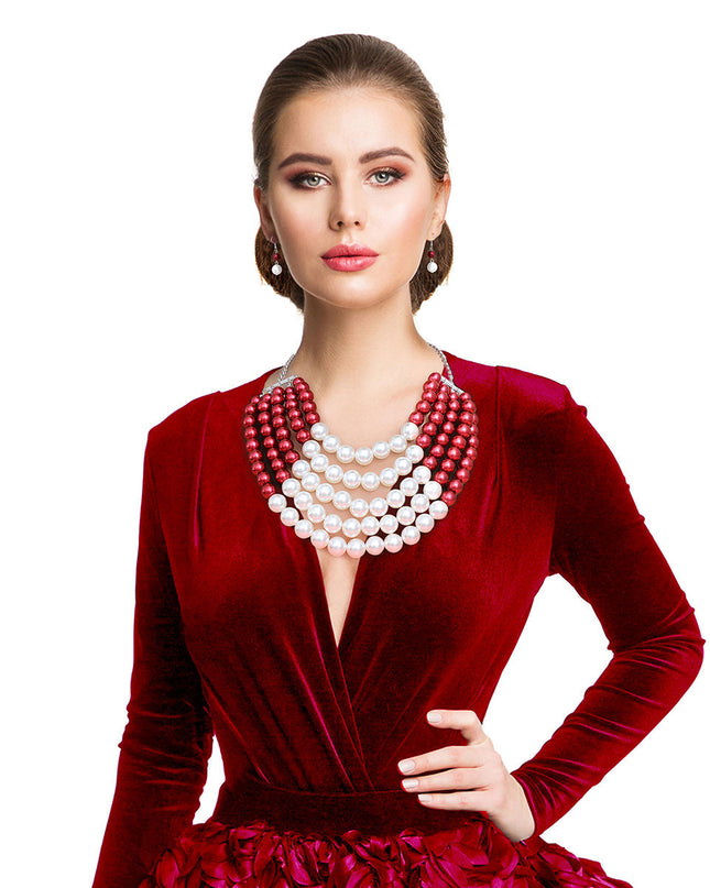  Featuring five cascading layers of lustrous cream pearls beautifully contrasted with bold red accents, this piece radiates sophistication and grace. The multi-strand design adds depth and drama, making it the perfect accessory for weddings or formal events