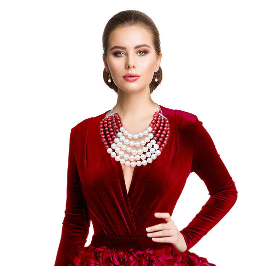  Featuring five cascading layers of lustrous cream pearls beautifully contrasted with bold red accents, this piece radiates sophistication and grace. The multi-strand design adds depth and drama, making it the perfect accessory for weddings or formal events