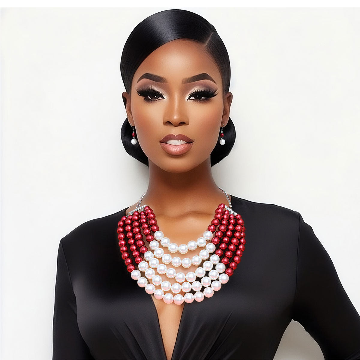  Featuring five cascading layers of lustrous cream pearls beautifully contrasted with bold red accents, this piece radiates sophistication and grace. The multi-strand design adds depth and drama, making it the perfect accessory for weddings or formal events