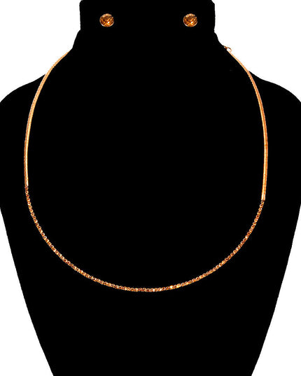 A gold metal short choker style necklace set with topaz stones
