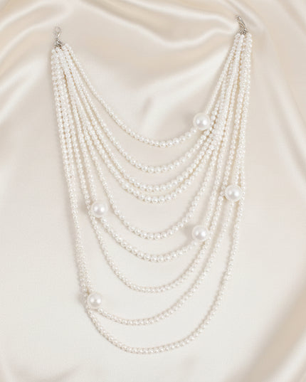 A bold 9‑strand white pearl necklace that adds instant shine and statement elegance to any look.